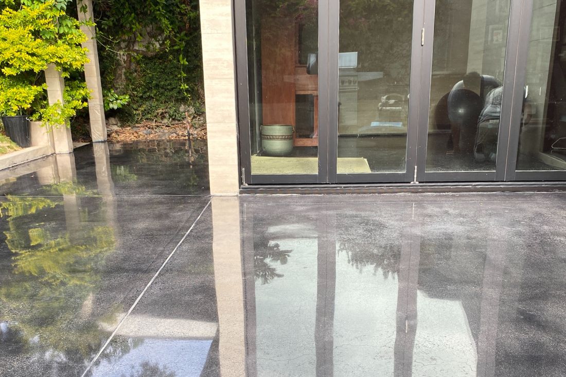 A polished concrete floor of a patio after StoneShine's concrete polishing service.
