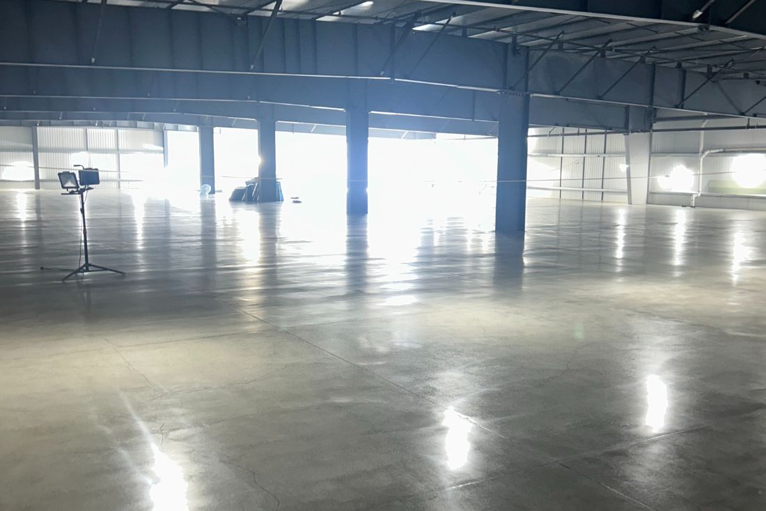 A polished concrete floor of an industrial facility after StoneShine's concrete polishing service.
