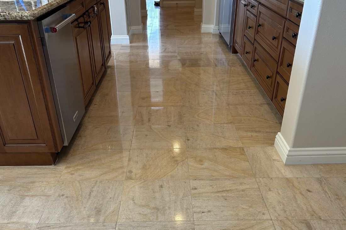 After StoneShine's limestone restoration service in Huntington Beach. The kitchen floor showcases a smooth, polished, and vibrant finish.