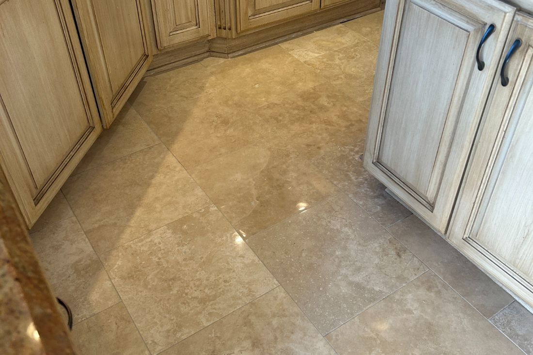 StoneShine travertine floor restoration in Mission Viejo, achieving a smooth, polished finish that enhances the kitchen’s natural elegance.