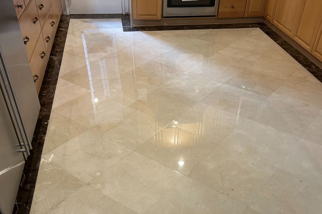 Marble floor restoration by StoneShine in Diamond Bar. The kitchen floor now features a vibrant, refreshed look, highlighting the stone’s natural veining and warm tones after a meticulous restoration.