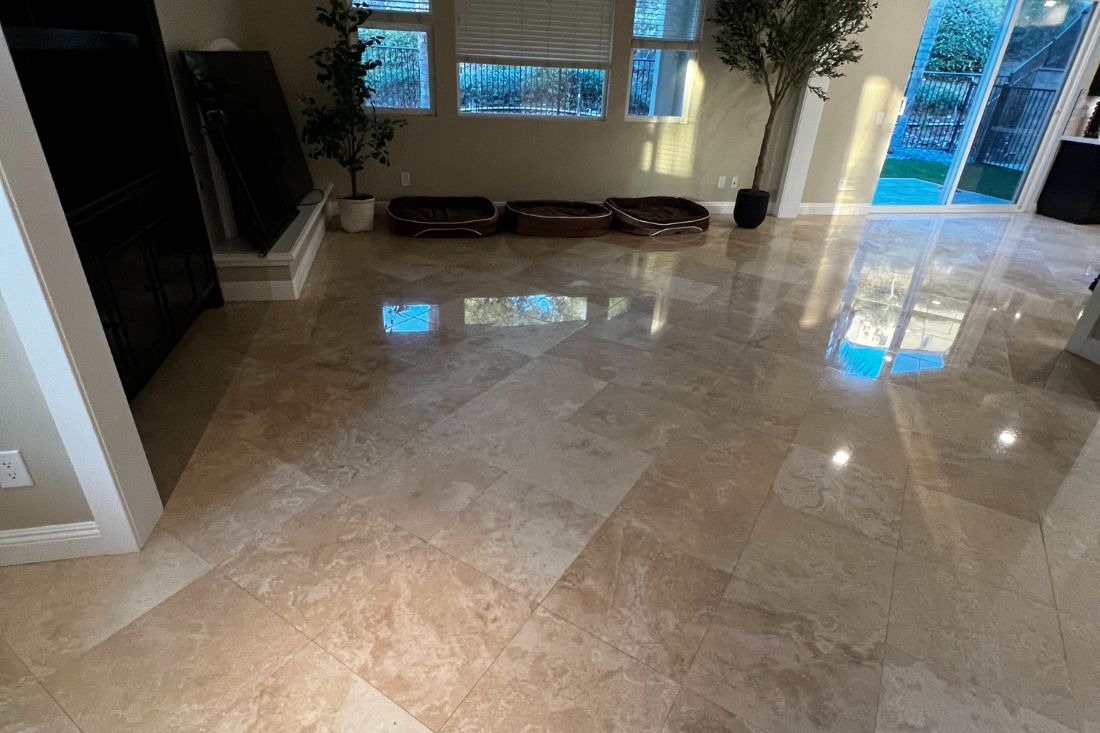 After StoneShine's travertine floor restoration in a Rancho Mirage living area. The natural stone surface now features a smooth, high-gloss finish that enhances light reflection and elevates the home's interior elegance.