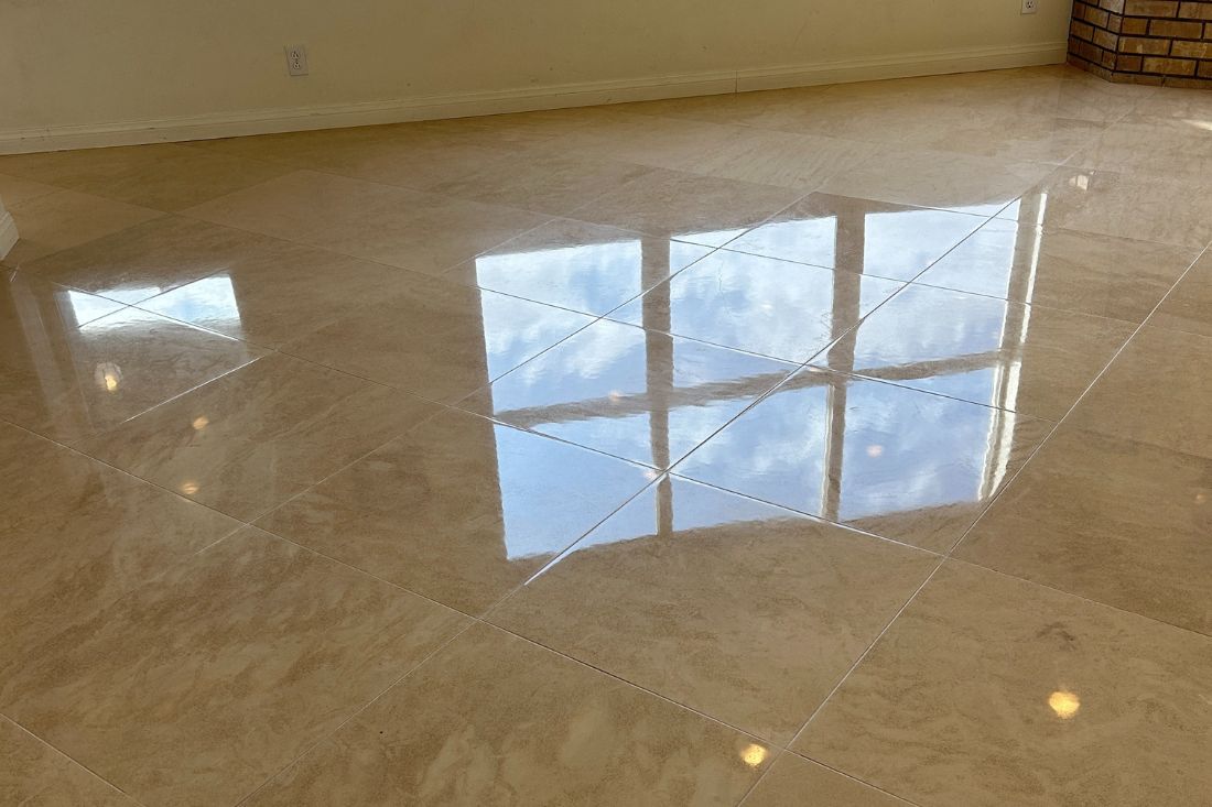 Polished limestone floor in a San Juan Capistrano living room after StoneShine's service, showing a smooth, glossy finish that brightens the space and reflects natural light.