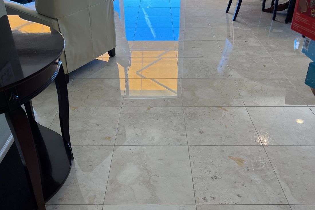 Polished marble flooring in a Los Angeles kitchen after refinishing by StoneShine. The surface now showcases a sleek, mirror-like finish that enhances the space's elegance and brightness.