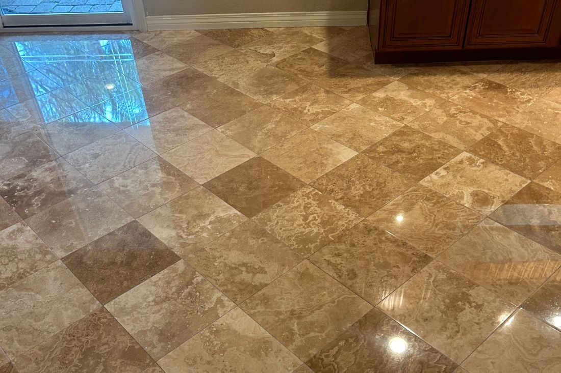 After view of StoneShine's travertine floor polishing service in Laguna Beach. The residential floor now features a high-gloss, reflective finish that enhances the natural stone patterns and brightens the space.