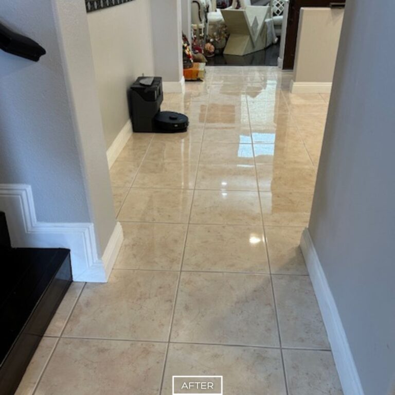 Shiny marble floor reflecting light after professional restoration in Orange residence