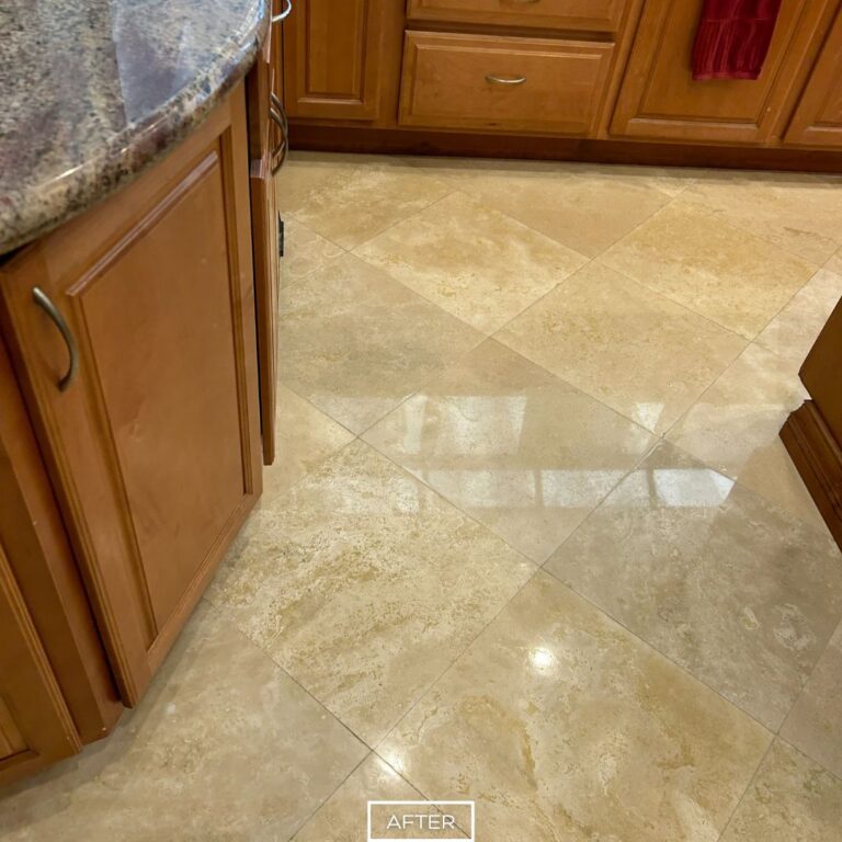 Polished travertine floor after restoration in Palm Desert kitchen near rounded granite countertop.