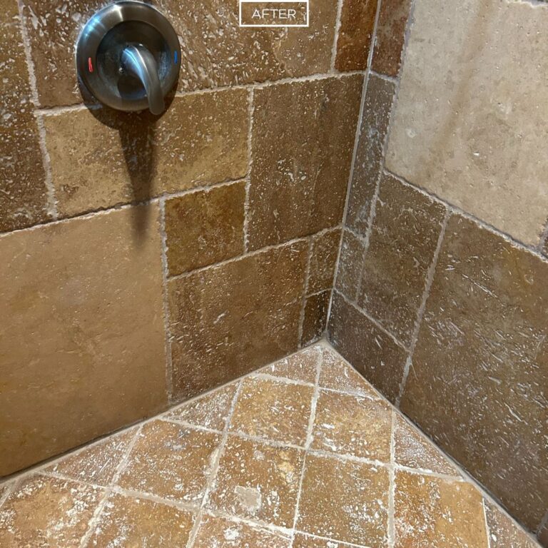 Travertine shower corner with renewed surface and improved grout lines after restoration in La Habra Heights