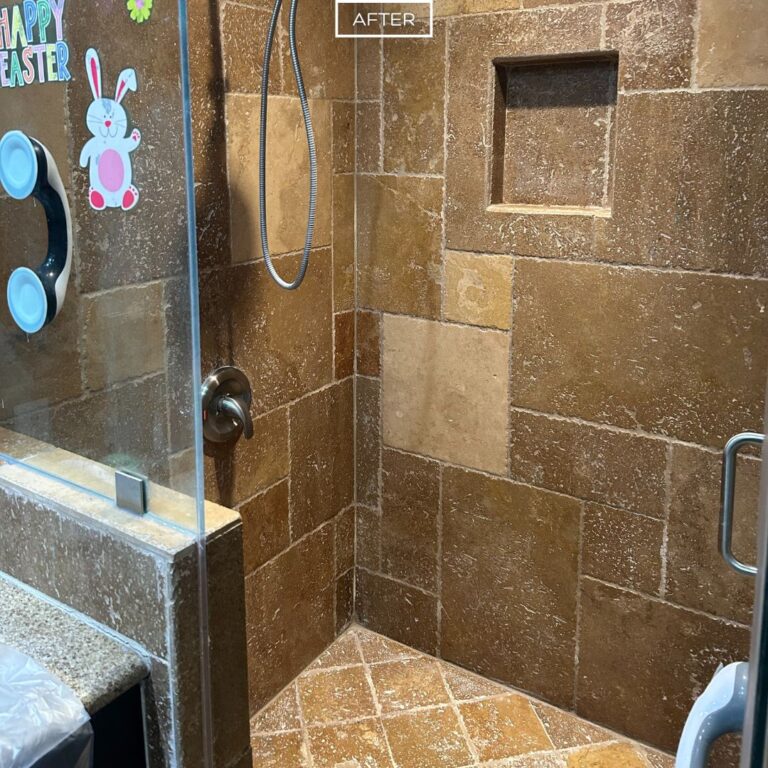Restored travertine shower with clean tiles and refreshed grout in La Habra Heights