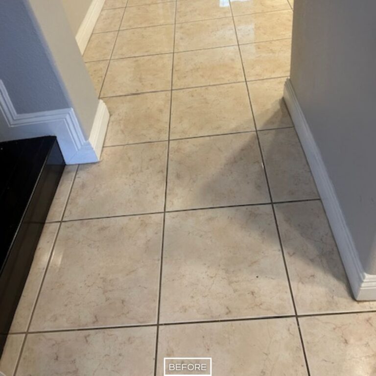 Lightly soiled marble tiles with dark grout lines before restoration in hallway in Orange home