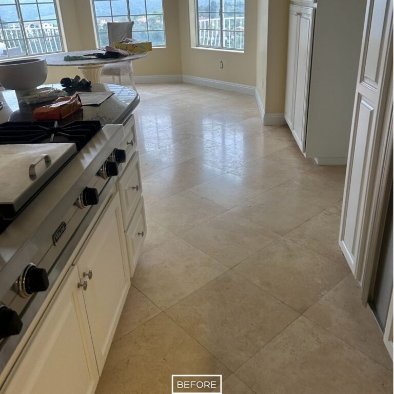Before travertine floor restoration in Diamond Bar showing a dull, uneven kitchen floor surface with visible wear and lack of shine across the tile area.