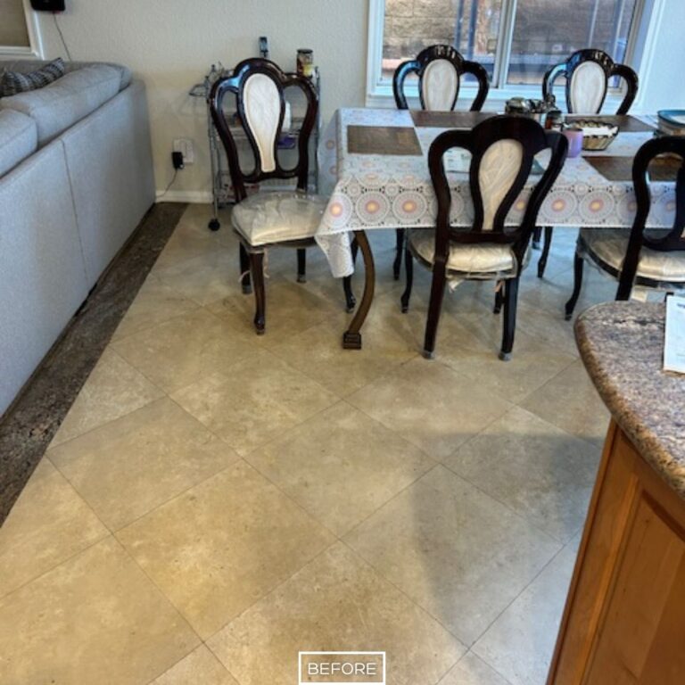 Dull travertine tiles before floor restoration in Palm Desert dining area.