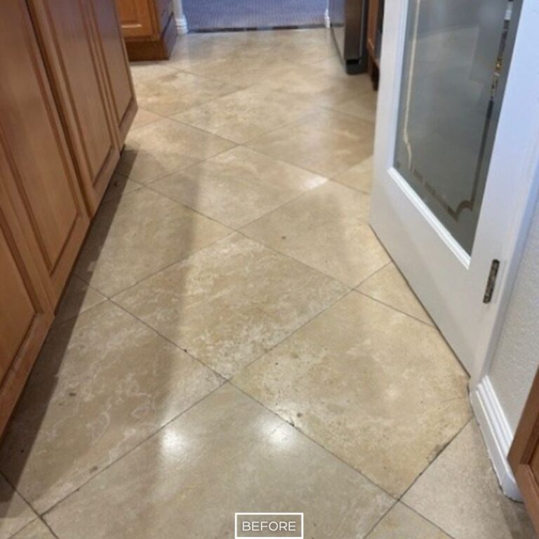 Worn travertine floor before restoration in Palm Desert kitchen hallway