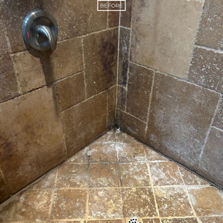 Dirty travertine shower corner with heavy soap scum and discoloration in La Habra Heights