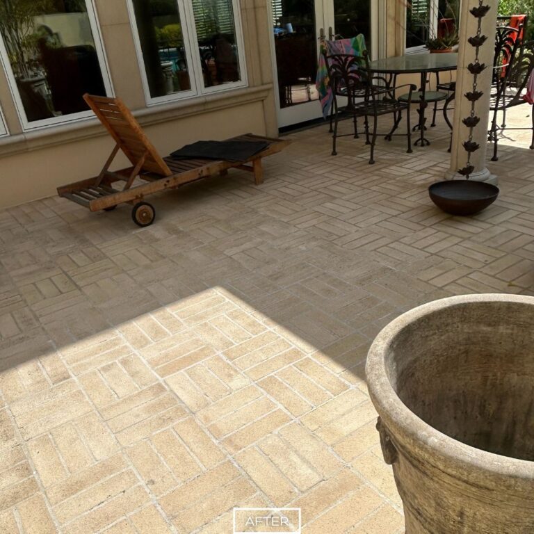 After restoration of outdoor concrete paver patio near lounge chair and dining area.