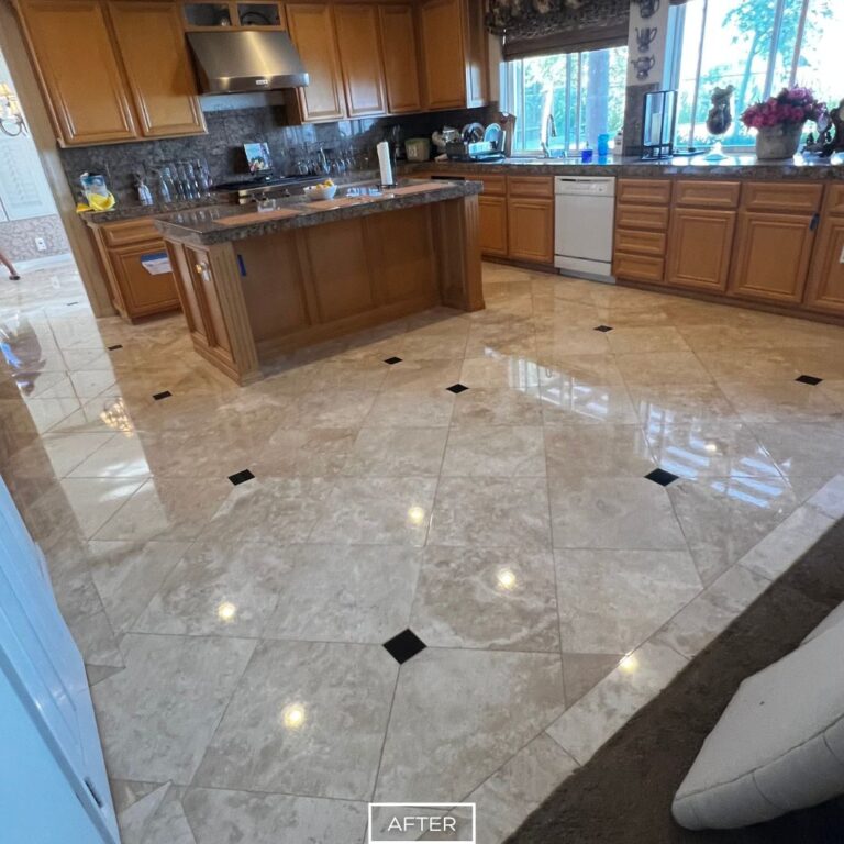 Restored travertine kitchen floor in Chino Hills with polished finish, enhancing brightness and complementing wooden cabinetry.