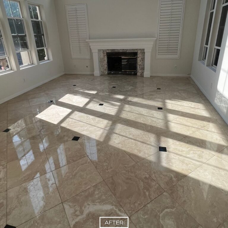 Polished travertine living room floor in Chino Hills with high-gloss finish, reflecting natural light near the fireplace.