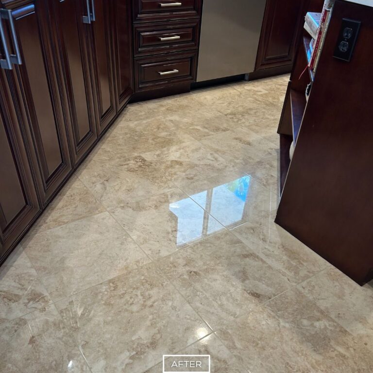 Restored travertine kitchen floor in Indian Wells with polished finish, reflecting light and enhancing the look of surrounding cabinetry.