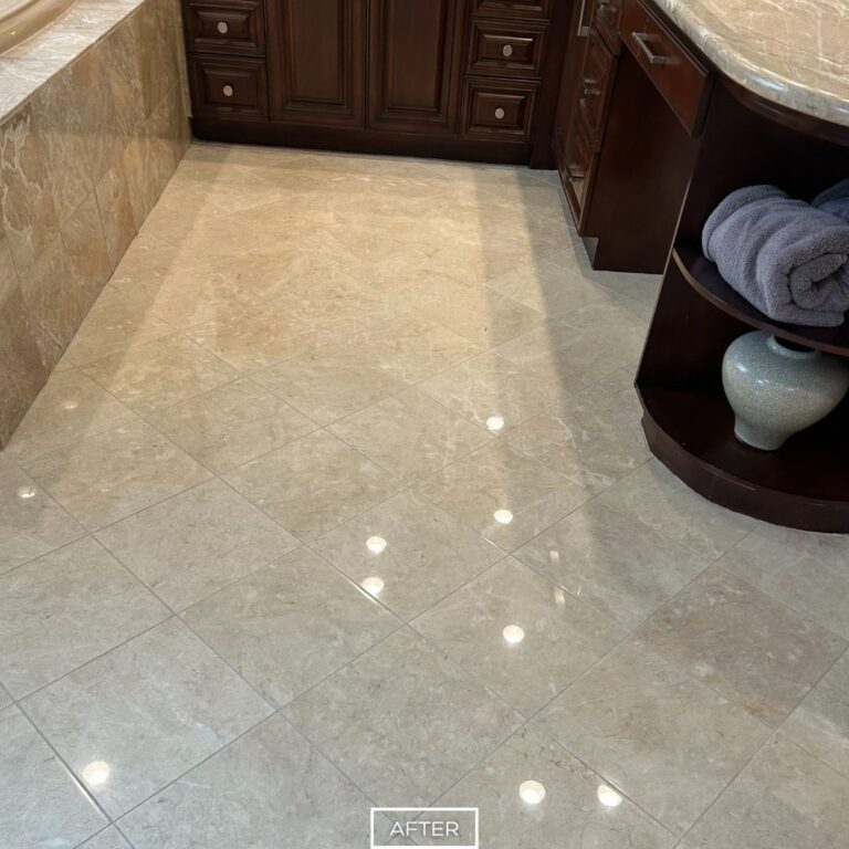 Travertine floor restoration in Indian Wells bathroom, with uniform glossy finish that highlights the natural stone’s elegance.