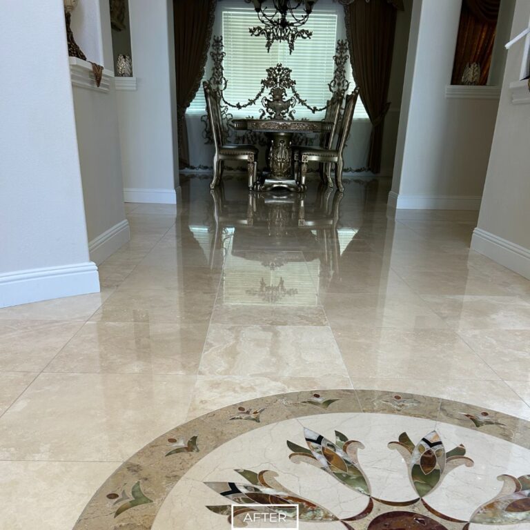 Restored travertine floor reflecting dining set with ornate chairs in Newport Beach home
