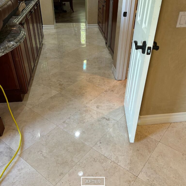 Polished travertine floor in San Clemente kitchen after restoration, reflecting light and showing a smooth, glossy finish.