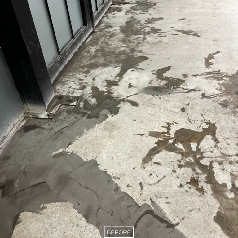 Damaged concrete flooring in Los Angeles warehouse with surface stains and rough patches before grinding service.
