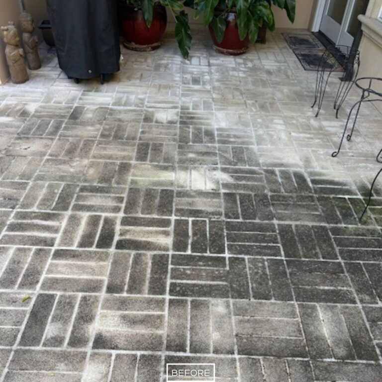 Before restoration of backyard concrete pavers in Beverly Hills, with visible staining, darkened areas, and fading from outdoor exposure.