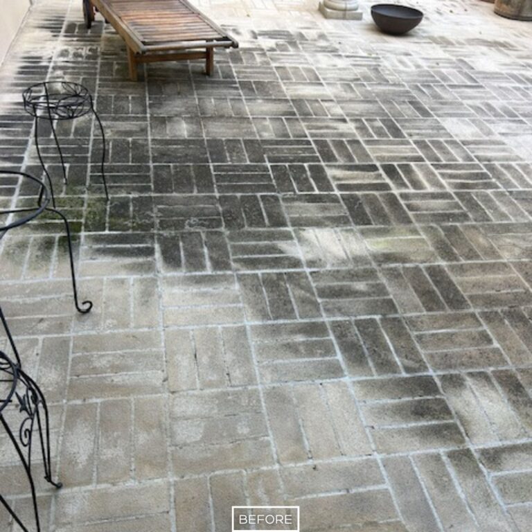 Before restoration of concrete paver patio in Beverly Hills, showing stained and darkened sections from dirt, algae, and water runoff.