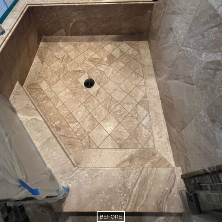 Worn marble shower floor in Yorba Linda home before restoration, with faded tiles and dull appearance near drain area.