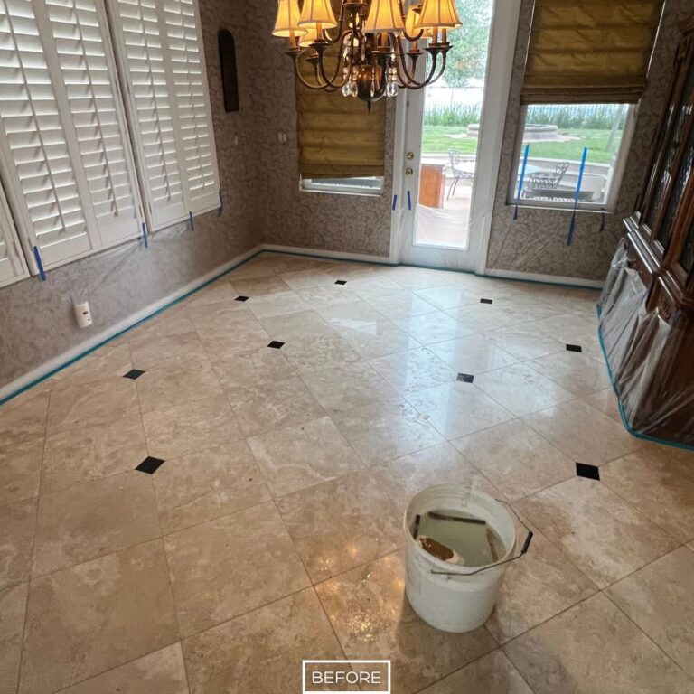 Travertine dining room floor in Chino Hills before restoration, showing dull surface and lack of shine beneath chandelier lighting.