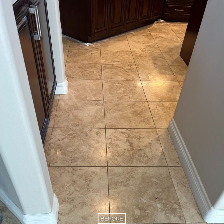 Worn travertine flooring in Indian Wells kitchen before polishing, with faded tiles and uneven appearance across the surface.