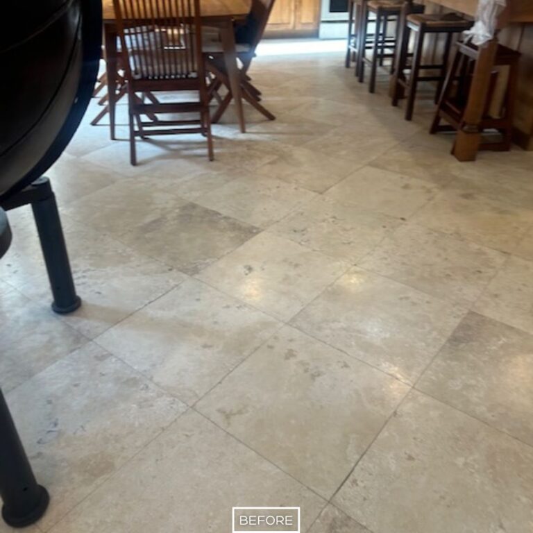 Worn travertine floor in dining area before restoration in Rancho Santa Margarita