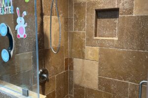 Travertine shower restoration project in La Habra Heights
