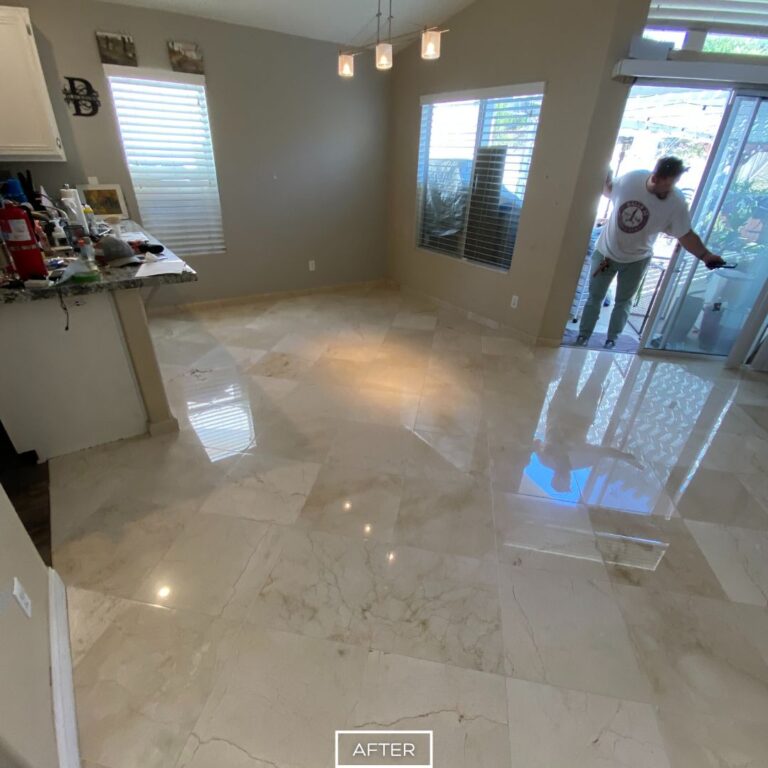 Polished marble floor in Los Angeles living room after restoration, with glossy reflective tiles enhancing natural stone patterns.