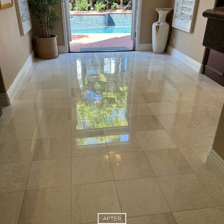 After marble floor restoration in Tustin living area near patio with polished reflective finish highlighting natural stone patterns.