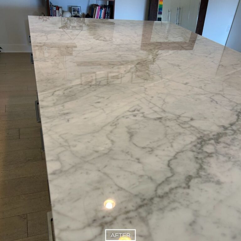 Smooth and glossy marble countertop after restoration, free of etches and stains, enhancing the modern kitchen setting.