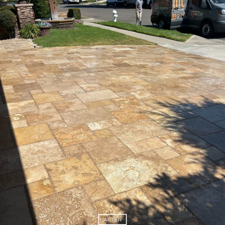 Refinished travertine driveway showcasing natural golden and beige variations after restoration.
