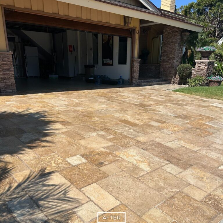 Clean and sealed travertine driveway surface with a bright, uniform finish.