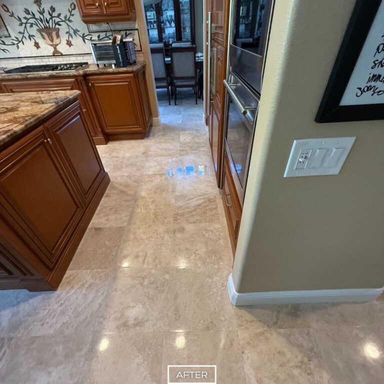 Beverly Hills kitchen entry travertine floor after refinishing, featuring a polished surface with enhanced color and reflection.