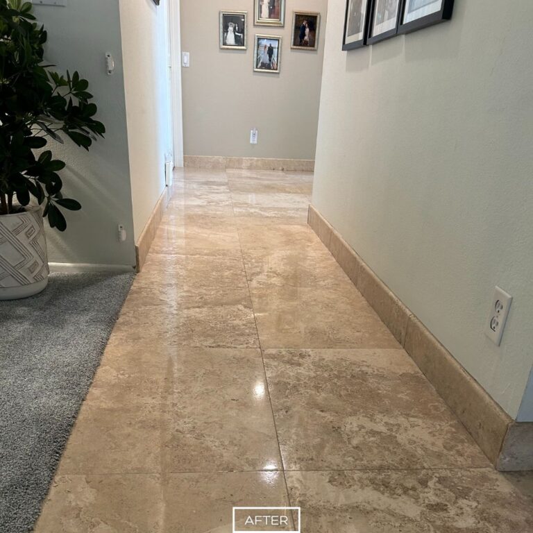 Travertine hallway floor in West Hollywood after restoration, featuring reflective shine and clean grout lines.