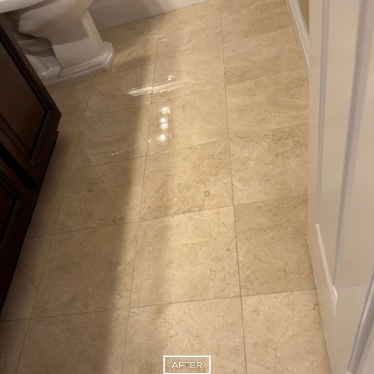 Polished travertine bathroom floor in Walnut after restoration, showing smooth reflective tiles with enhanced brightness.