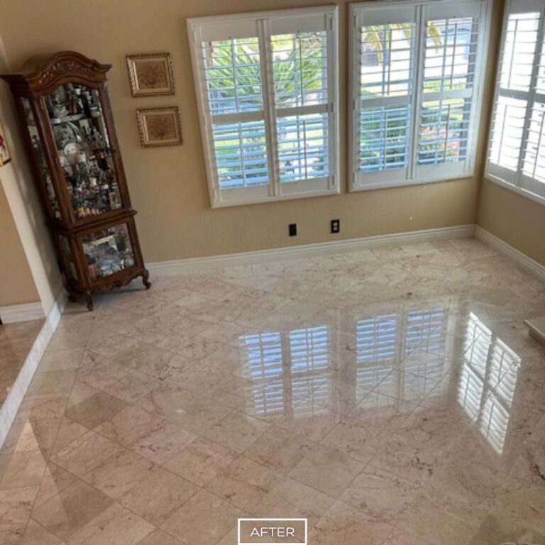 Travertine floor restoration in Walnut living room, with highly polished tiles reflecting natural light from large windows.