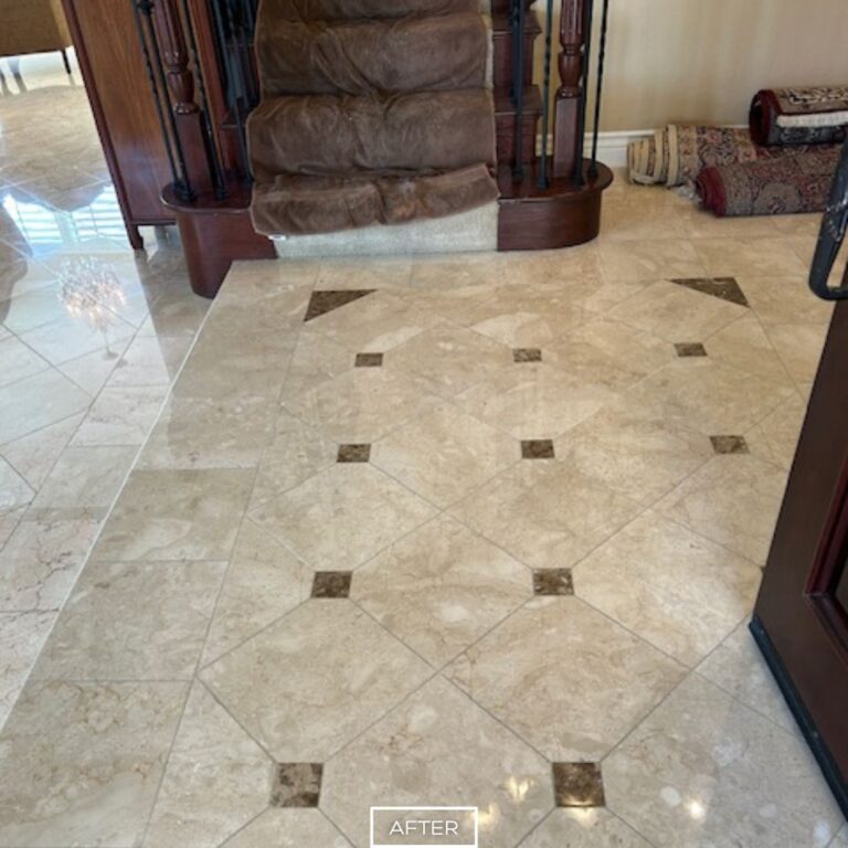 Restored travertine entryway floor in Walnut home, featuring polished finish and patterned tile design with strong reflective shine.