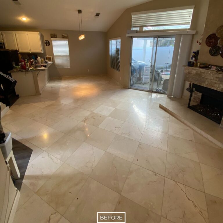 Marble floor in Los Angeles living room before restoration, with dull tiles and visible wear near the kitchen area.