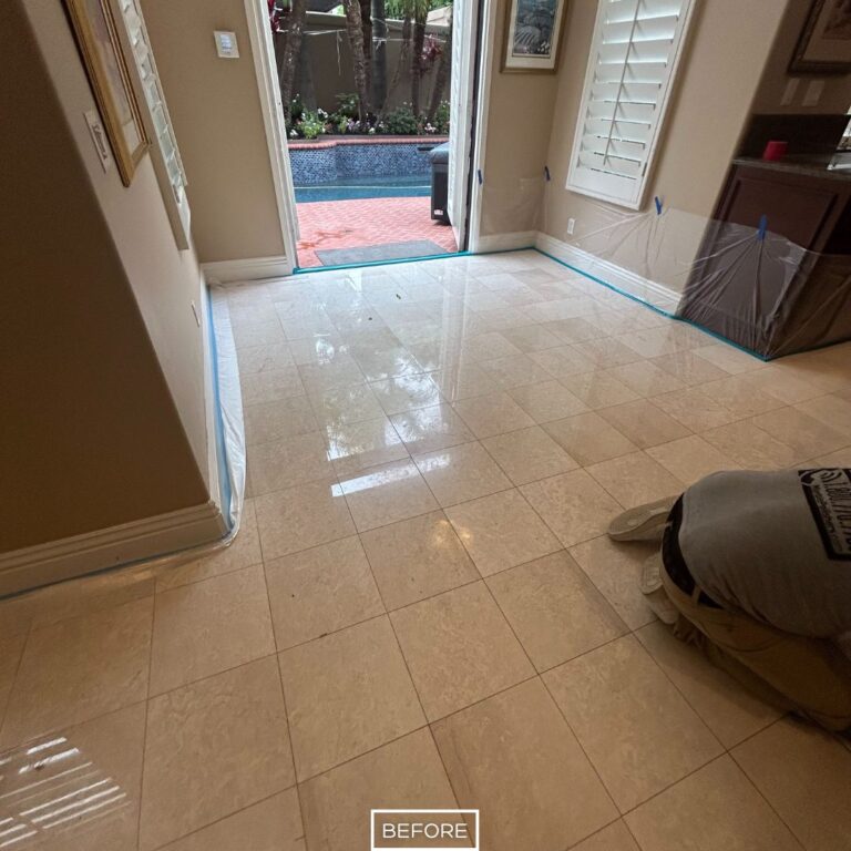 Before marble floor restoration in Tustin living area near patio showing dull, uneven tiles with protective coverings prepared for the process.