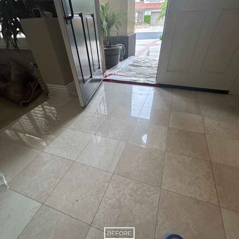 Before marble floor restoration in Tustin front entryway with cloudy, worn tiles lacking shine and natural reflection.