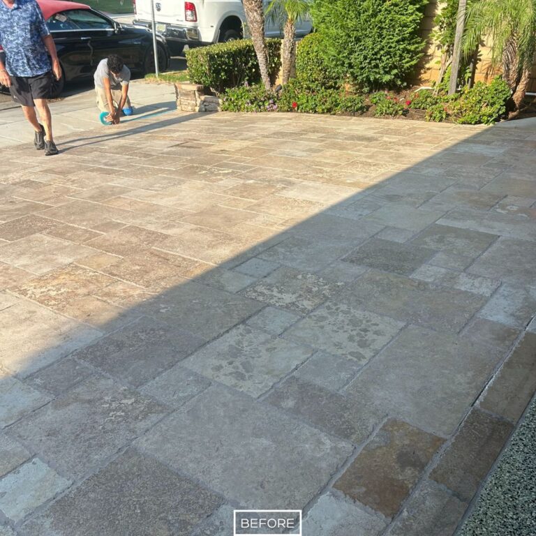 Dull travertine driveway surface in need of deep cleaning, sanding, and sealing.