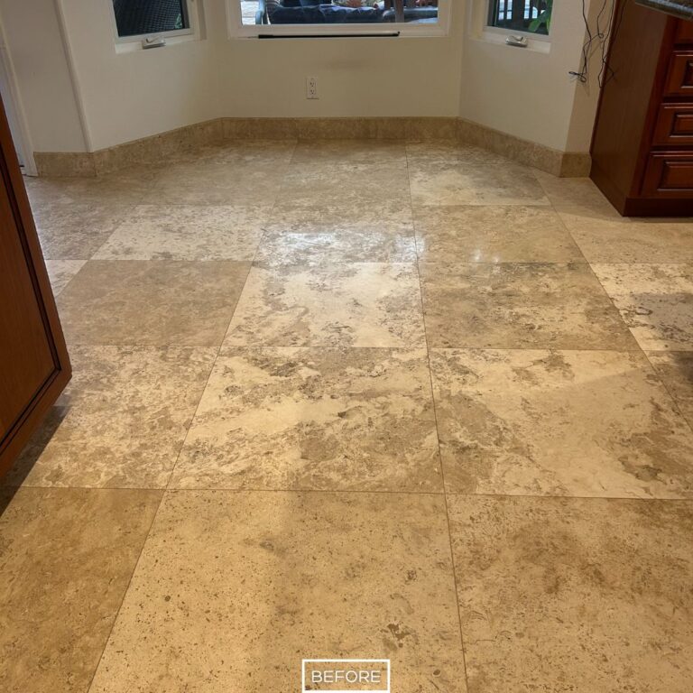 Before travertine floor restoration in West Hollywood dining area showing dull tiles and worn stone surface.