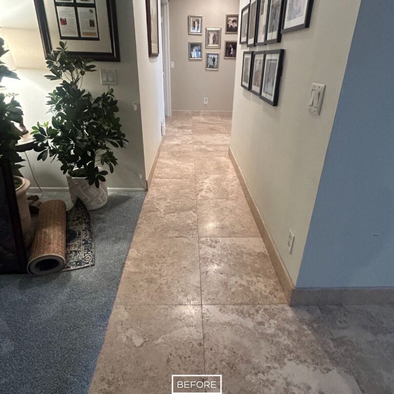 Travertine hallway floor in West Hollywood before restoration, showing stains, dirt, and dull stone finish.