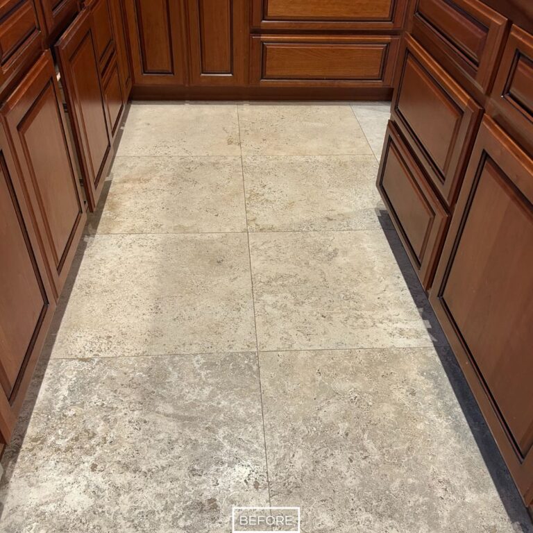 Kitchen travertine walkway in West Hollywood before polishing, with etched tiles and faded appearance.